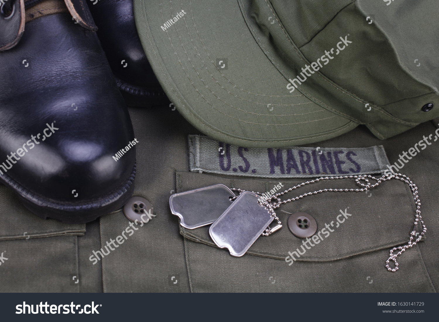 U.S. MARINES Branch Tape with dog tags and boots on olive green uniform background #1630141729