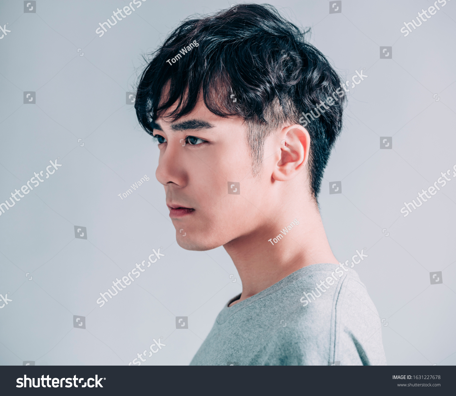 side view of young smiling handsome man isolated on gray background #1631227678