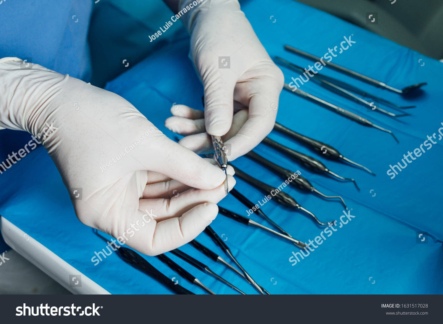Detail of hand holding dental tools in dental clinic. Dental clinic. #1631517028