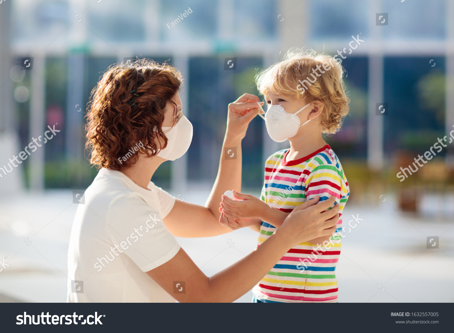 Family with kids in face mask in shopping mall or airport. Mother and child wear facemask during coronavirus and flu outbreak. Virus and illness protection, hand sanitizer in public crowded place. #1632557005
