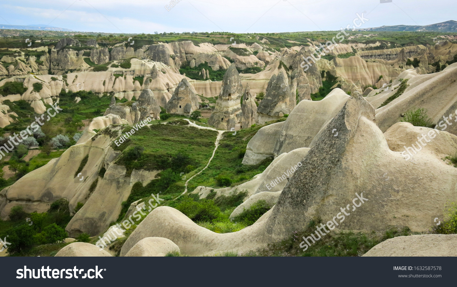 The wonderful nature of Urgup with lots of stone caves through the valley. A mushroom rocks, also called rock pedestals, or Fairy chimneys at the valley near Urgup, Cappadocia, Turkey.  #1632587578