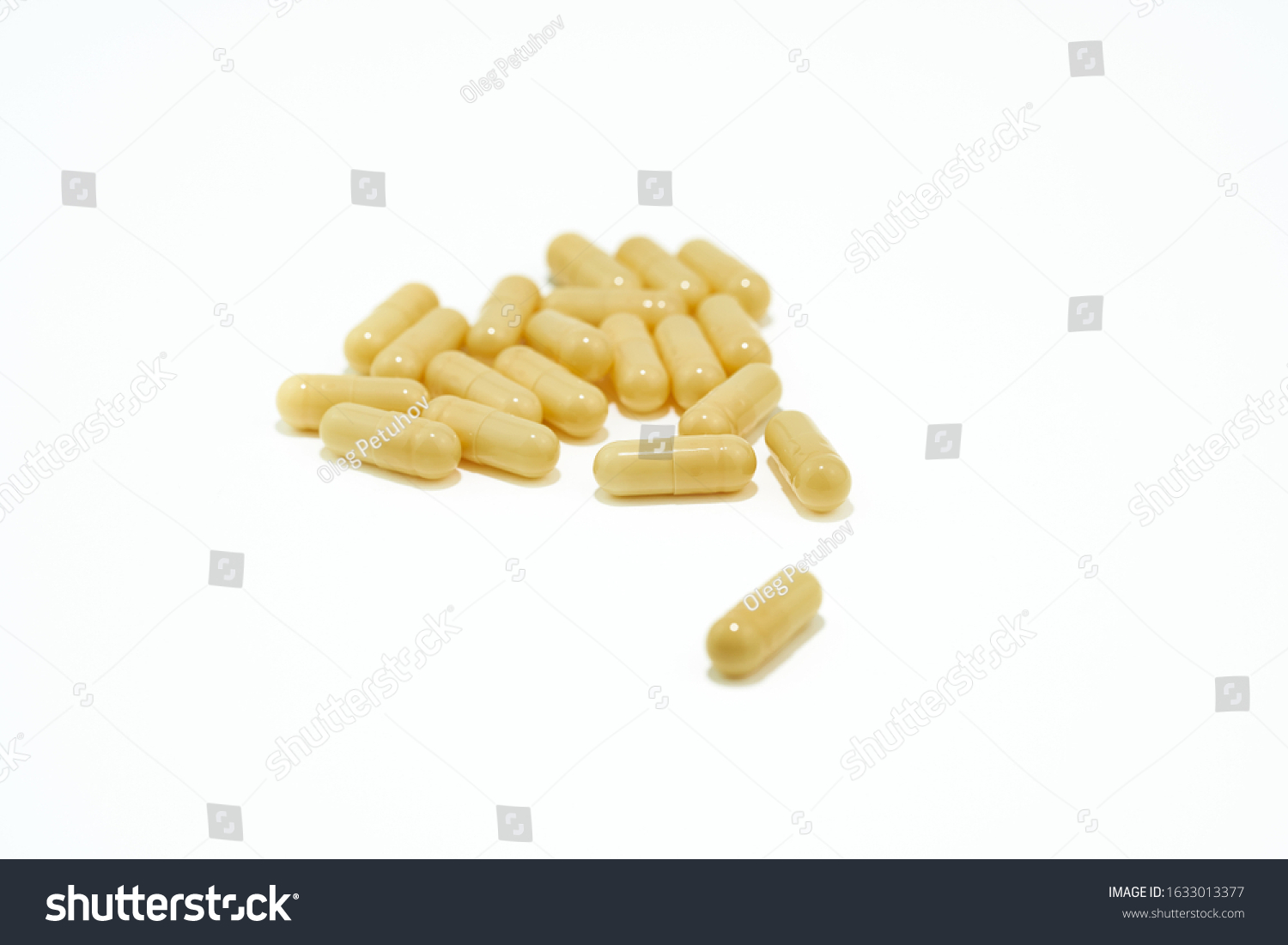 Yellow pills an pill bottle on white background. #1633013377