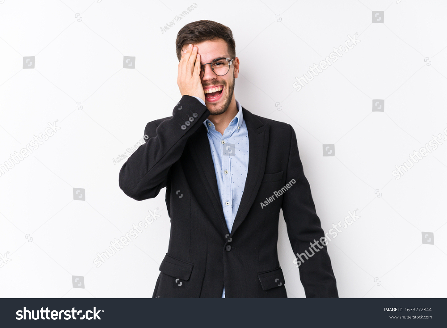Young caucasian business man posing in a white background isolated Young caucasian business man having fun covering half of face with palm. #1633272844