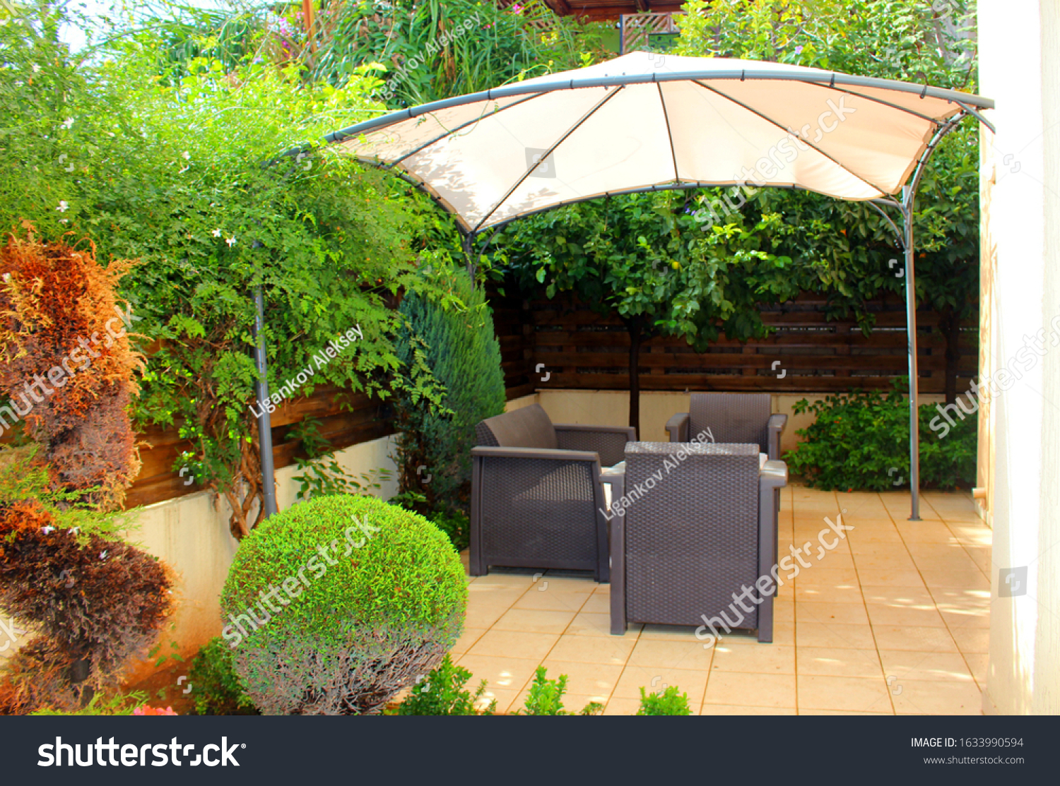 View of a summer holiday destination with armchairs and a parasol #1633990594