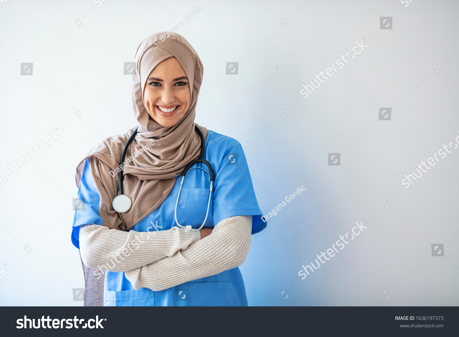 Closeup portrait of friendly, smiling confident muslim female nurse. Authentic Confident Middle Eastern Healthcare Worker. Middle age senior arab nurse woman wearing hijab over isolated background #1636197373