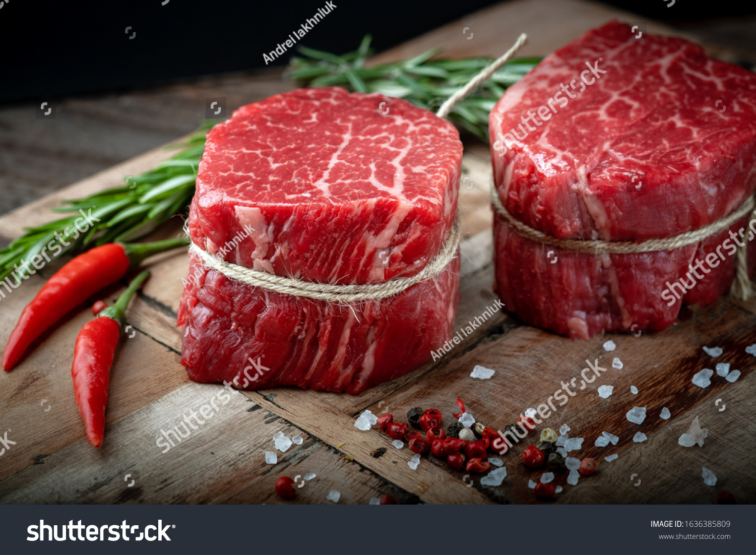 Raw beef filet Mignon steak on a wooden Board with pepper and salt, black Angus marbled meat #1636385809
