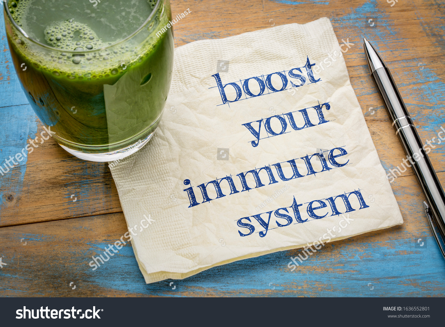boost your immune system - inspirational handwriting on a napkin with a glass of fresh, green, vegetable juice, healthy lifestyle and wellbeing concept #1636552801