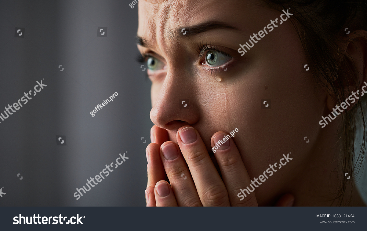 Sad desperate grieving crying woman with folded hands and tears eyes during trouble, life difficulties, depression and emotional problems #1639121464