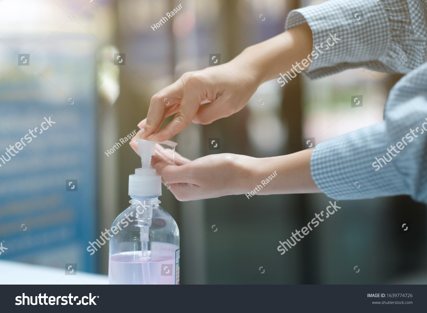 A girl using alcohol gel for cleaning hands #1639774726