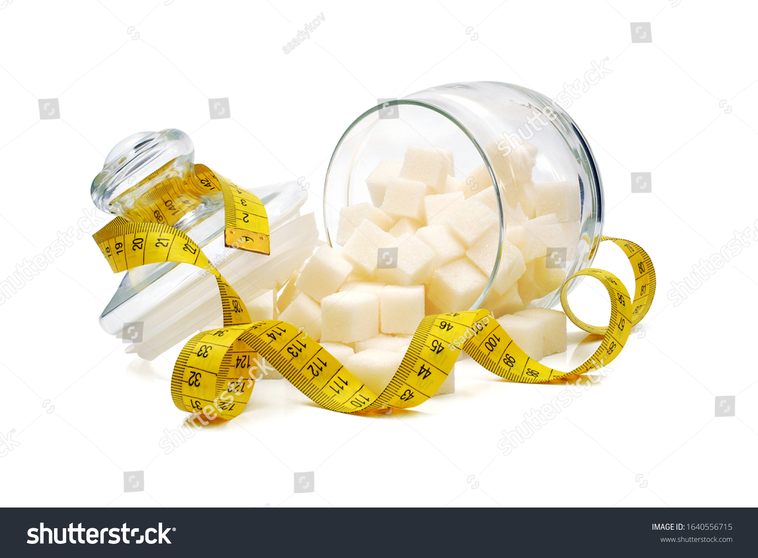 sugar cubes spilled from overturned glass sugar bowl and wrapped by tape measure isolated on white background #1640556715