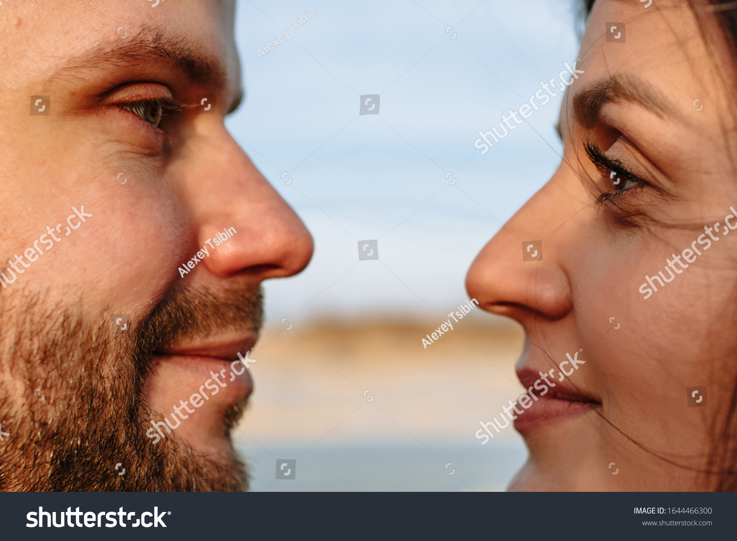 Faces of a guy and a girl. Guy and girl look at each other #1644466300