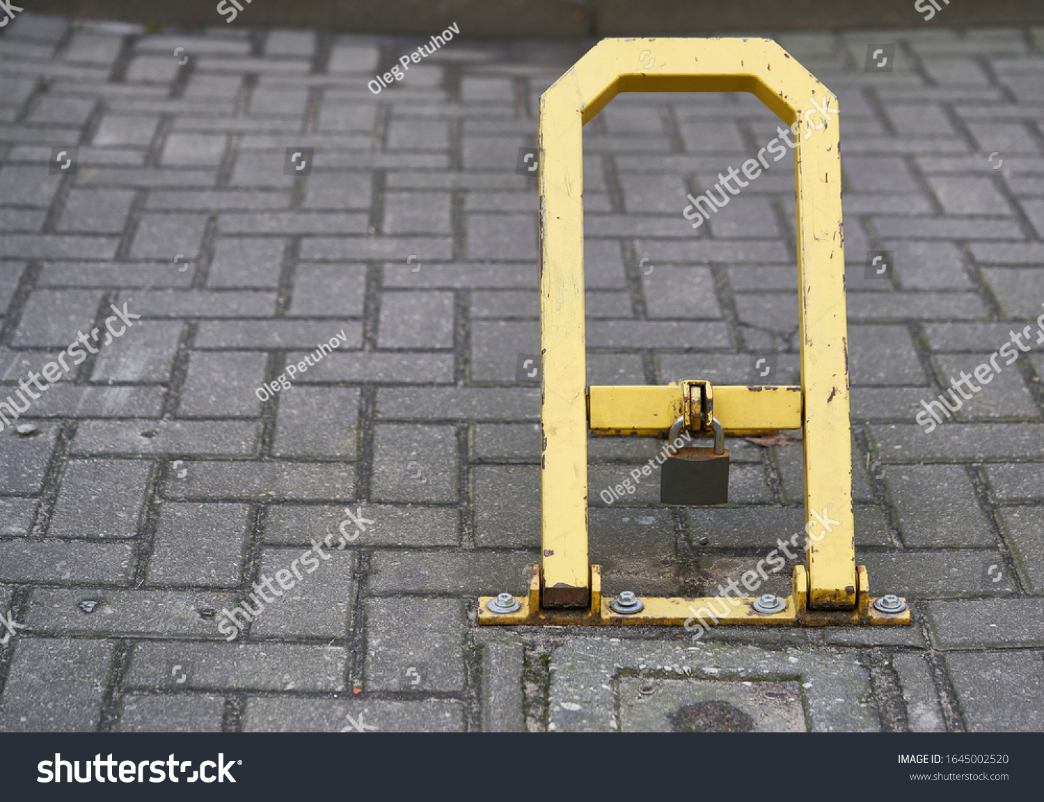 Manual car parking barrier with lock and stop sign. Car parking lock device. Dedicated parking for guests. Traffic rules, prohibitory signs #1645002520