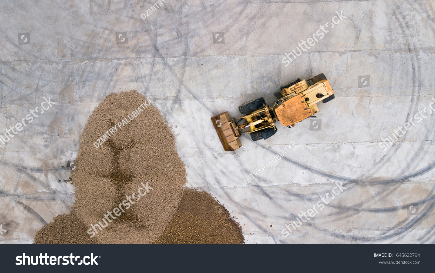 the loader loads the potatoes, top view #1645622794
