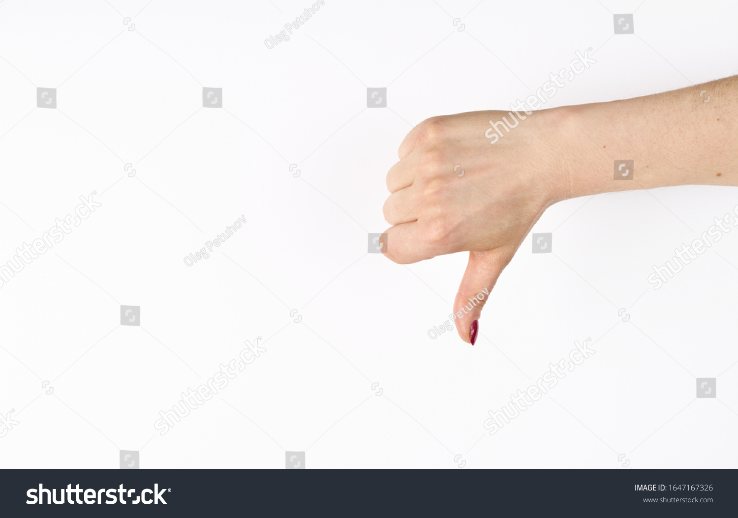 Hand thumb down isolated on the left side on white background. Rejection symbol #1647167326