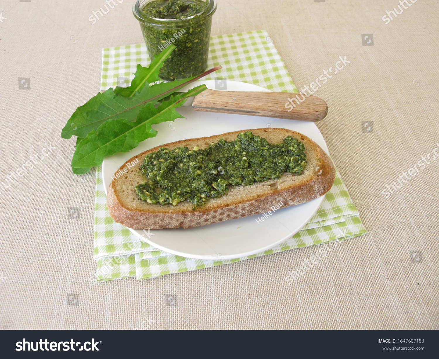 Dandelion pesto, green pesto with dandelion on a slice of bread #1647607183
