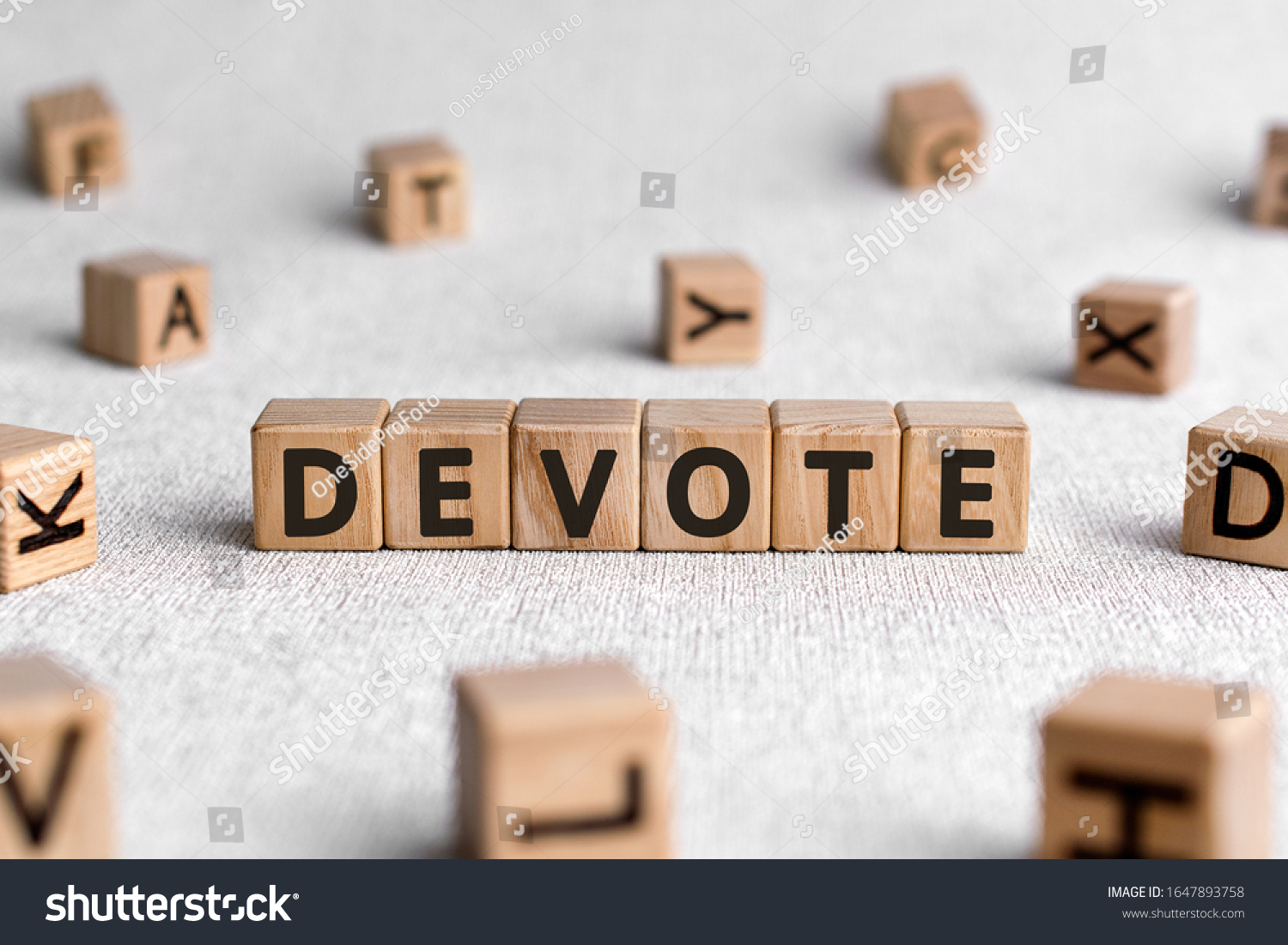 Devote - words from wooden blocks with letters, to give all of something devote concept, white background #1647893758