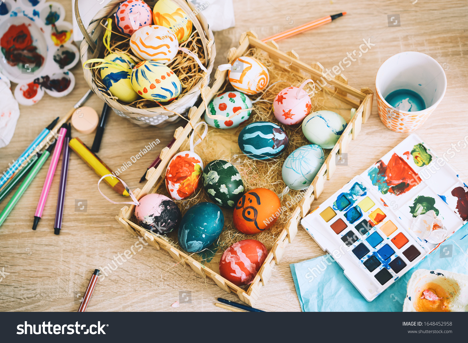 Happy Easter! Painting eggs. Paints, felt-tip pens, decorations for coloring eggs for holiday. Creative background. Family with kids preparing for Easter. #1648452958