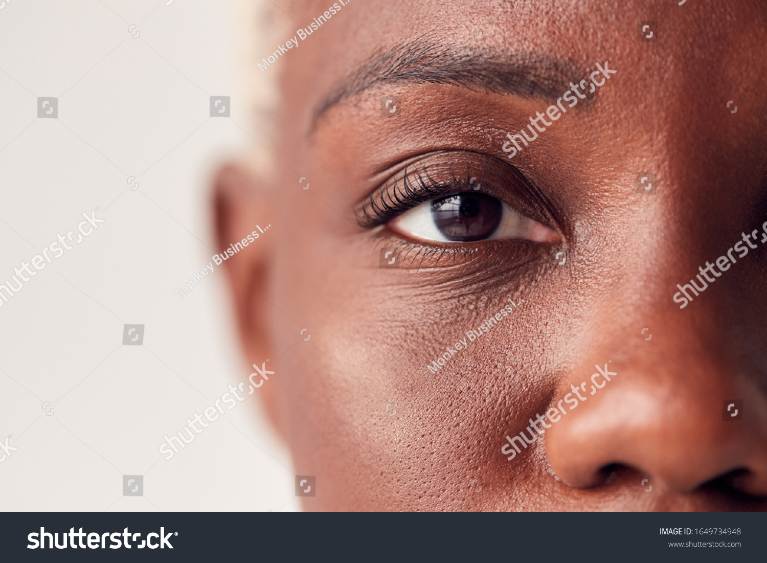 Close Up On Eyes Of Young Woman With Dyed Hair In Studio #1649734948