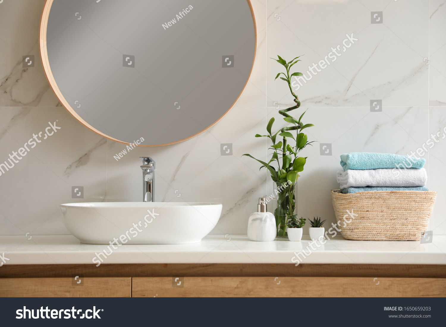 Beautiful green plants near vessel sink on countertop in bathroom. Interior design elements #1650659203