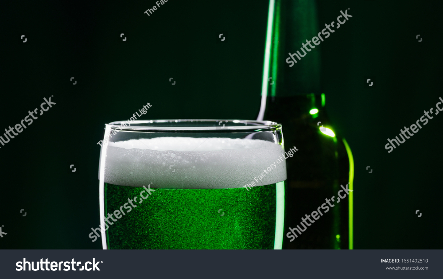 Glass of green beer and bottle. St. Patrick's Day concept. #1651492510