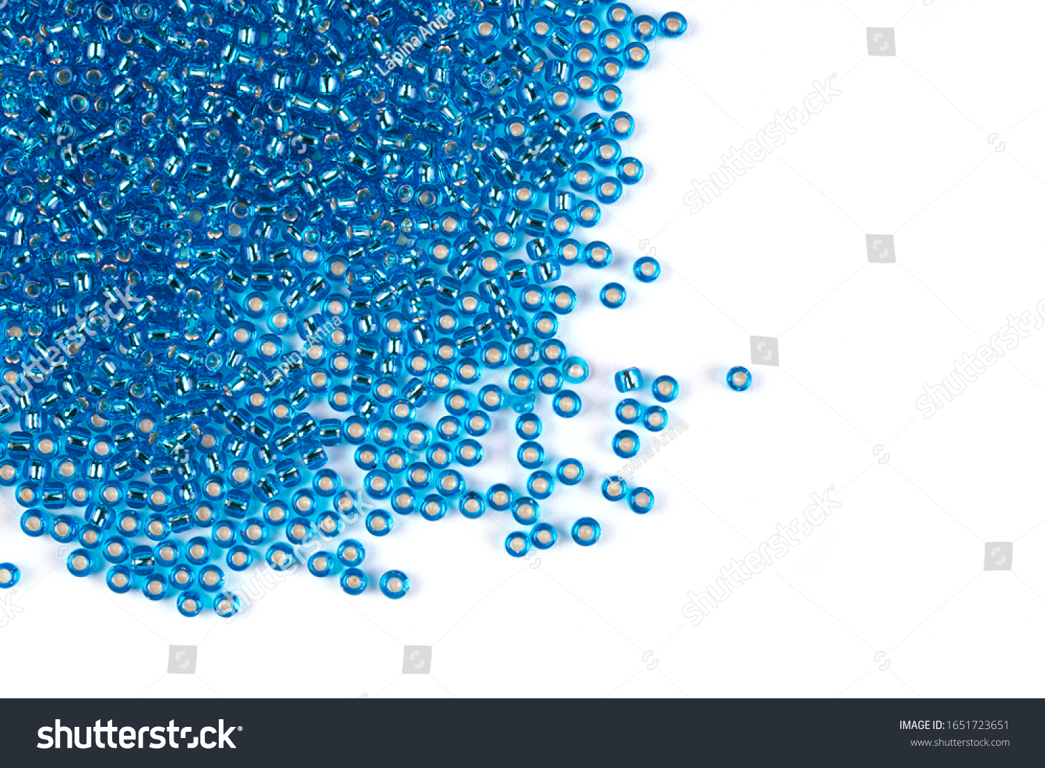 Blue beads scattered beads on a white background, top view, costume jewelry #1651723651