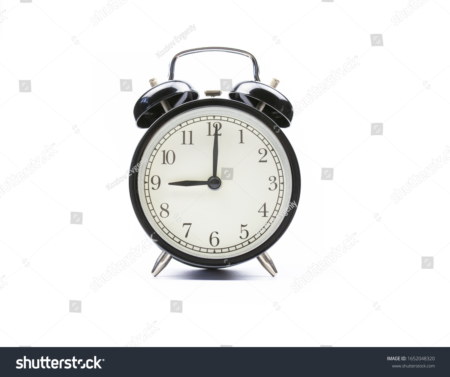 Black vintage alarm clock on a white background shows nine o'clock #1652048320