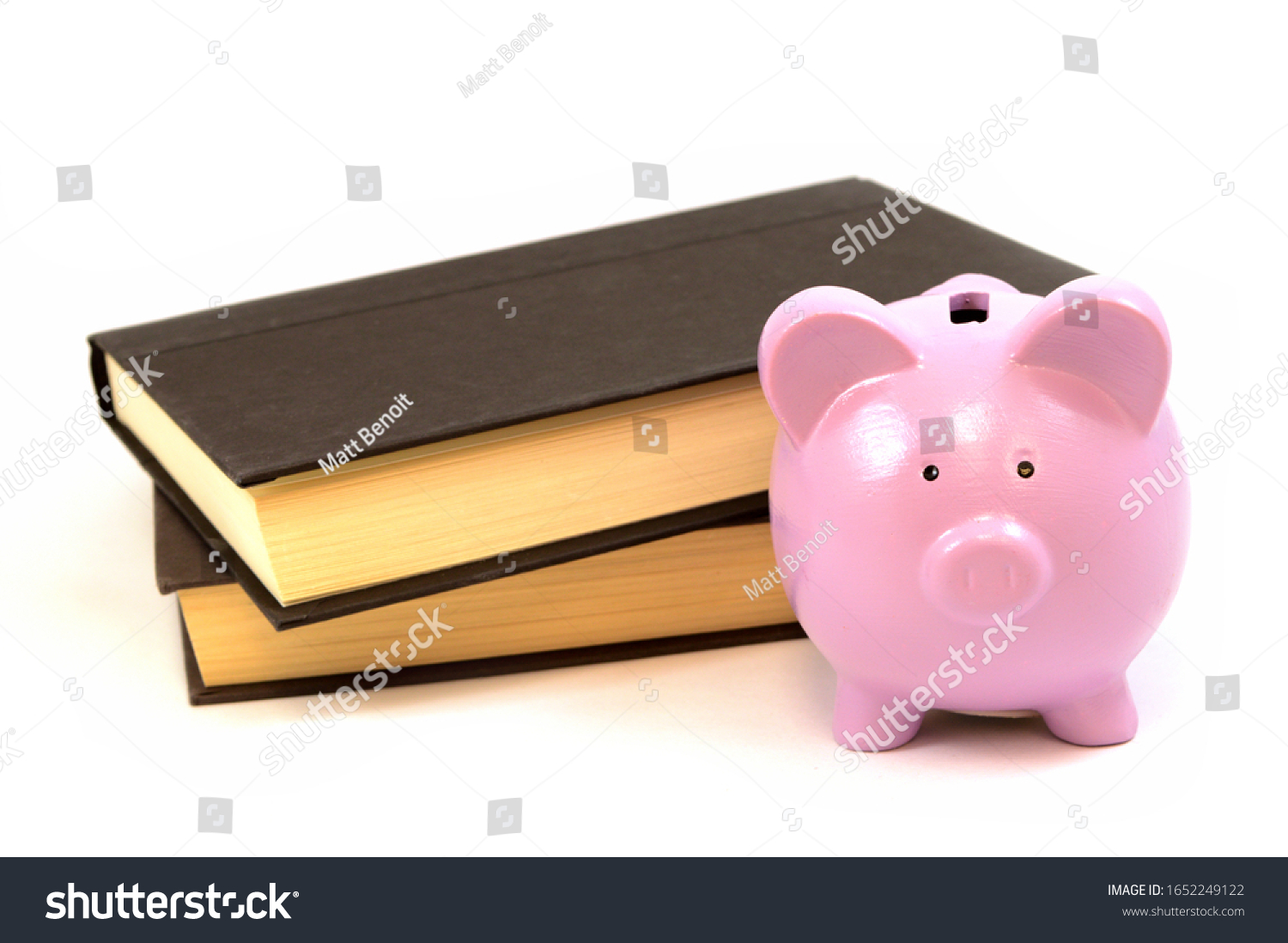An isolated set of books and a piggy bank. #1652249122