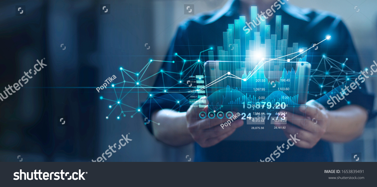 Businessman holding tablet and checking analyzing sales data growth graph chart and stock market on global networking. Business strategy, planning and digital marketing on blue background. #1653839491