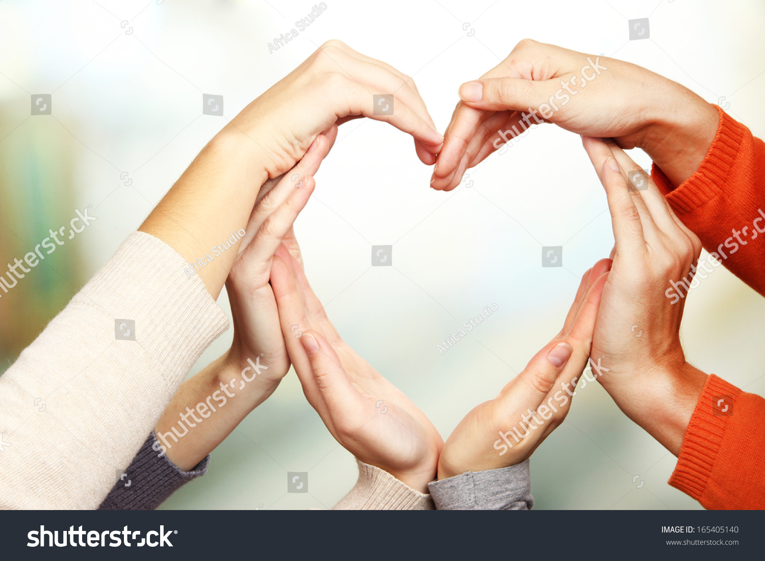 Human hands in heart shape on bright background #165405140