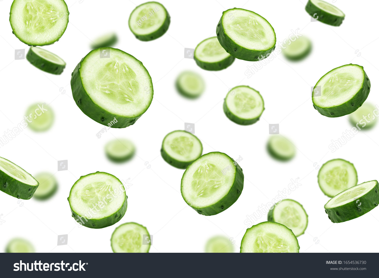 Falling cucumber slice isolated on white background, selective focus #1654536730