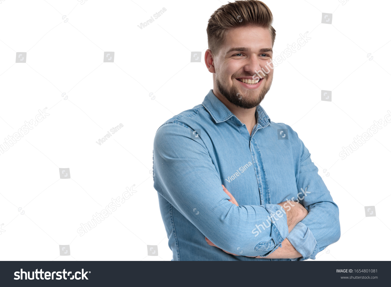 Cheerful casual man smiling and holding his hands folded at his chest, standing on white studio background #1654801081