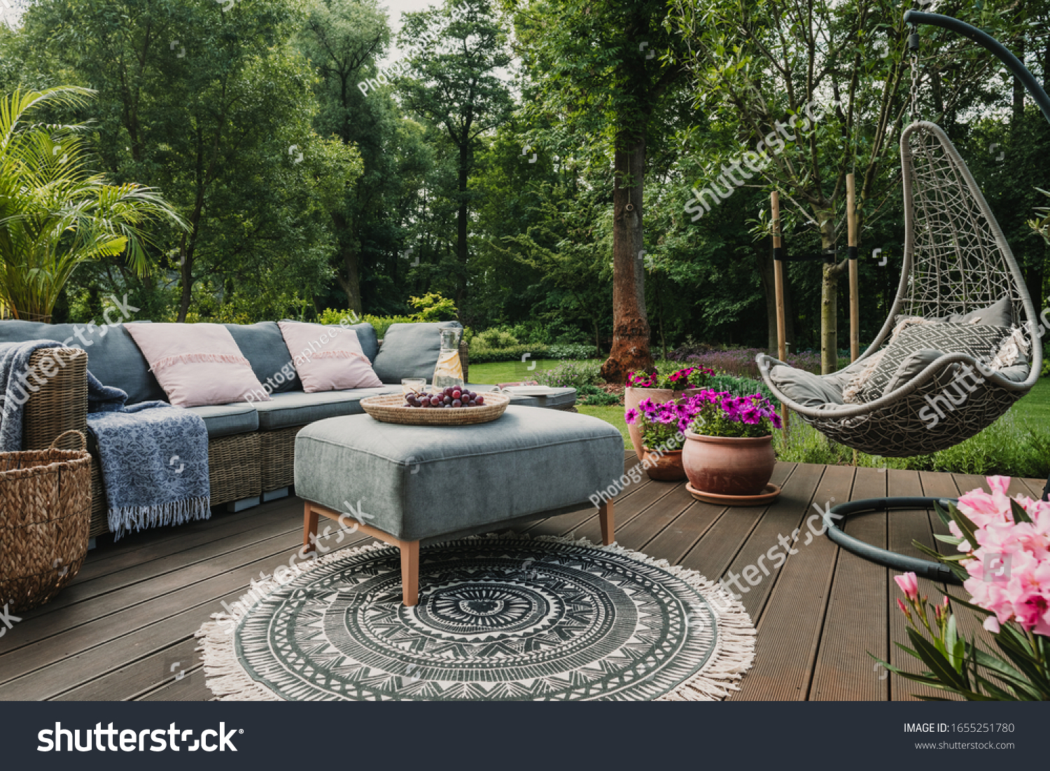 Garden patio decorated with Scandinavian wicker sofa and coffee table #1655251780