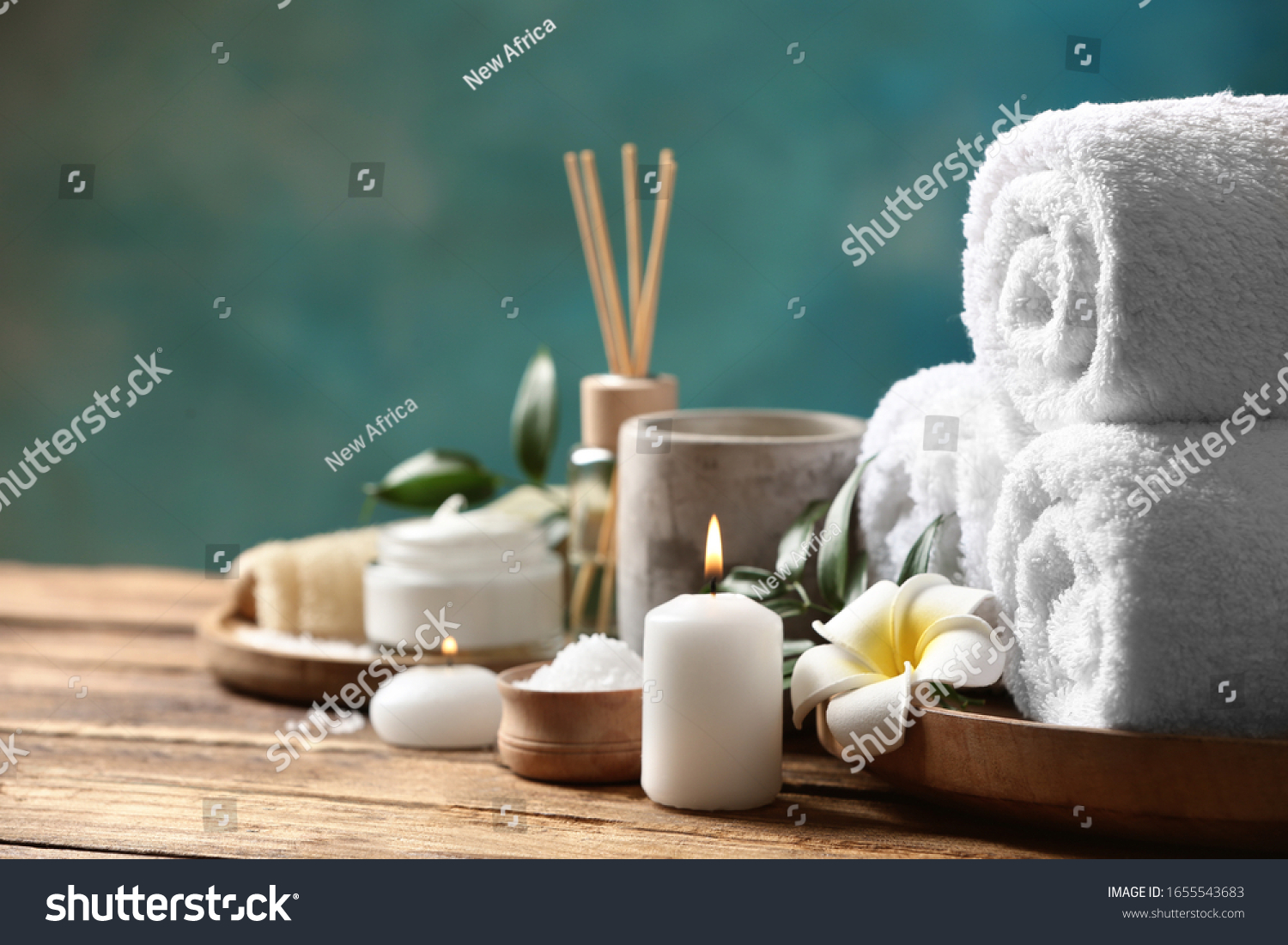 Beautiful spa composition with plumeria flower on wooden table. Space for text #1655543683