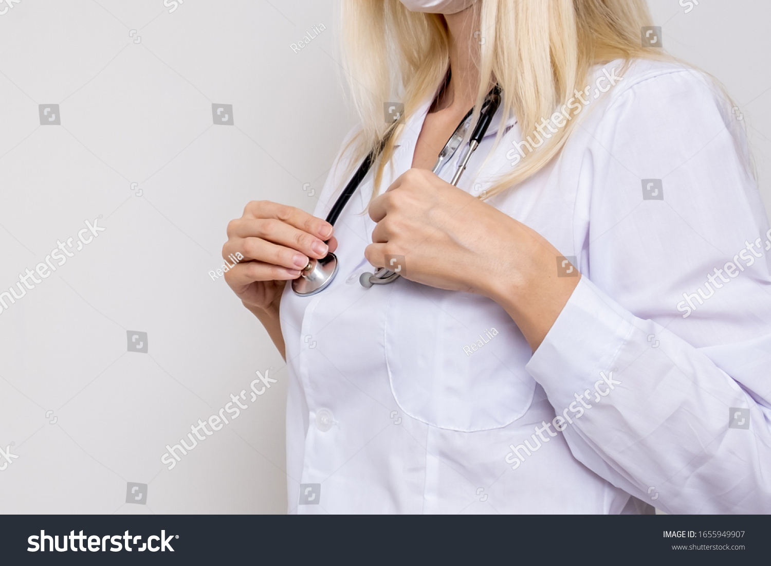 Unrecognizable woman doctor physiotherapist in white uniform with stethoscope on white background. #1655949907