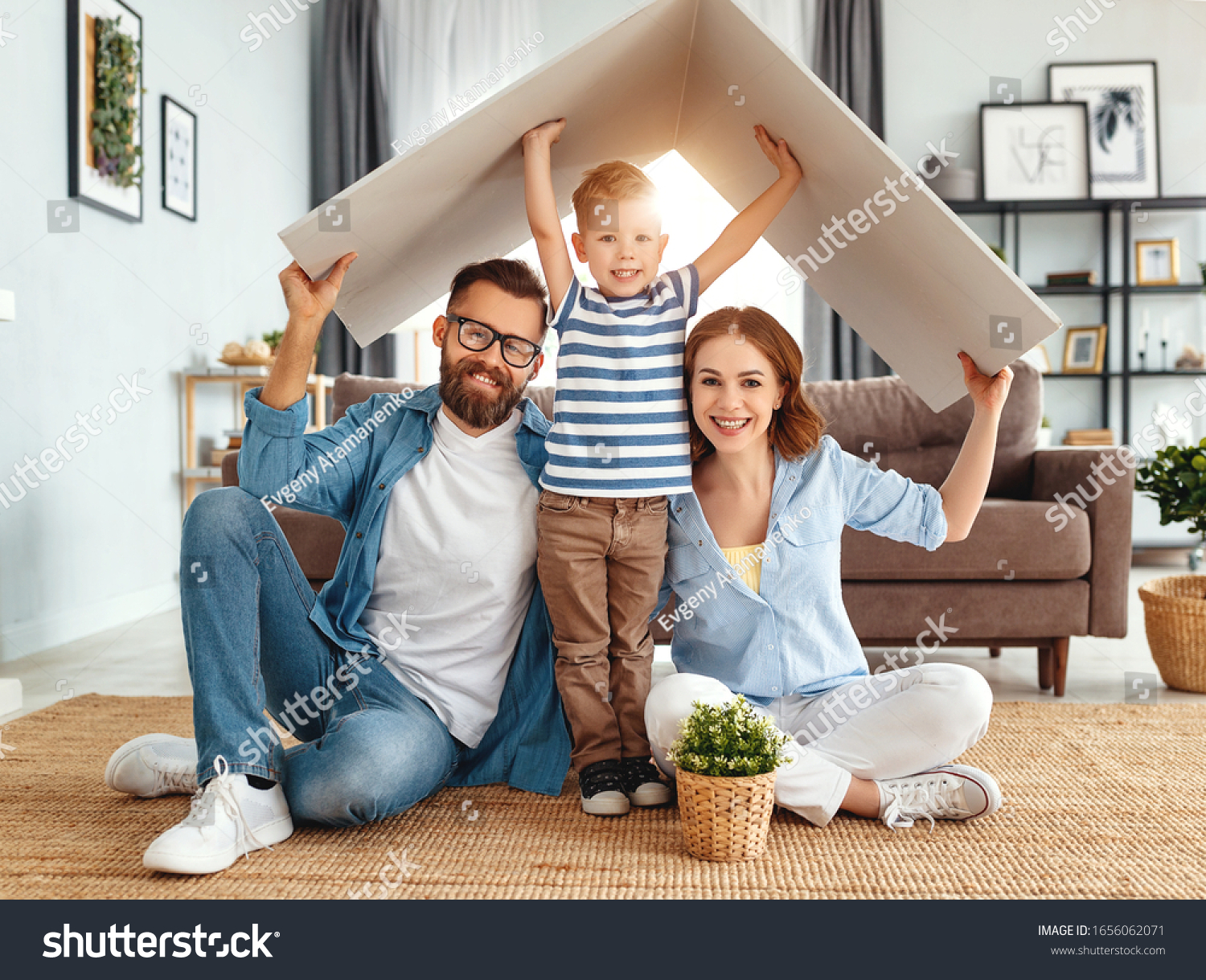concept housing a young family. Mother father and child in new house with a roof at a home
 #1656062071