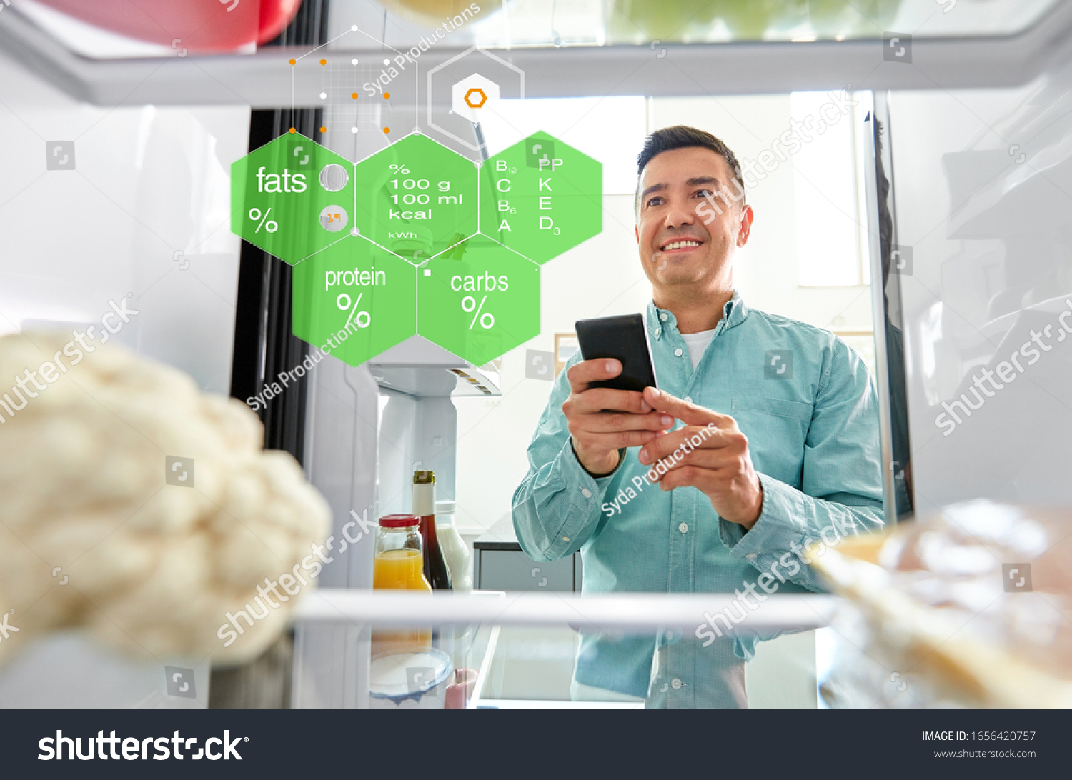 healthy eating, technology and diet concept - happy middle-aged man with smartphone at fridge at home kitchen over food nutritional value chart #1656420757