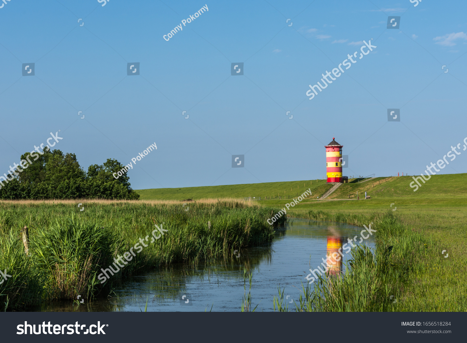 Pilsum Lighthouse with Reflection in Water, East Frisia, Lower Saxony, Germany #1656518284