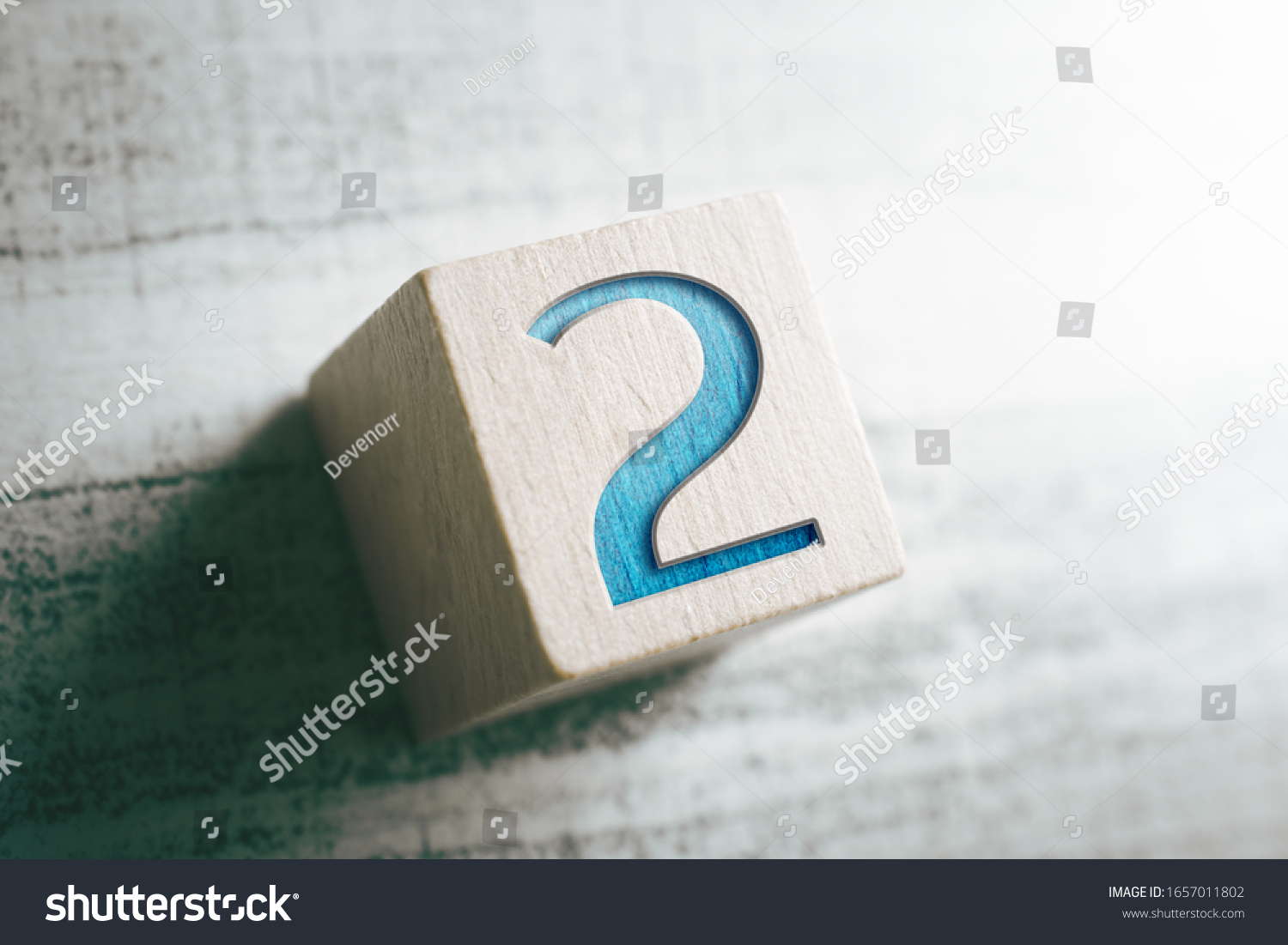 Number 2 On A Wooden Block On A Table #1657011802