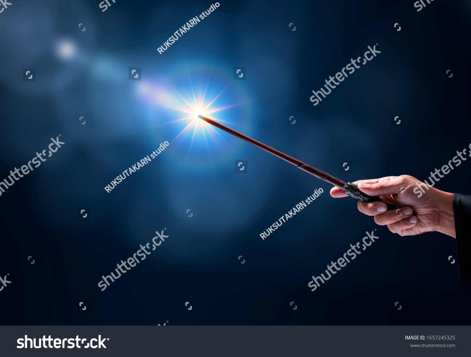 Magic wand with sparkle on blue background, Miracle magical stick Wizard tool on hot blue. #1657245325