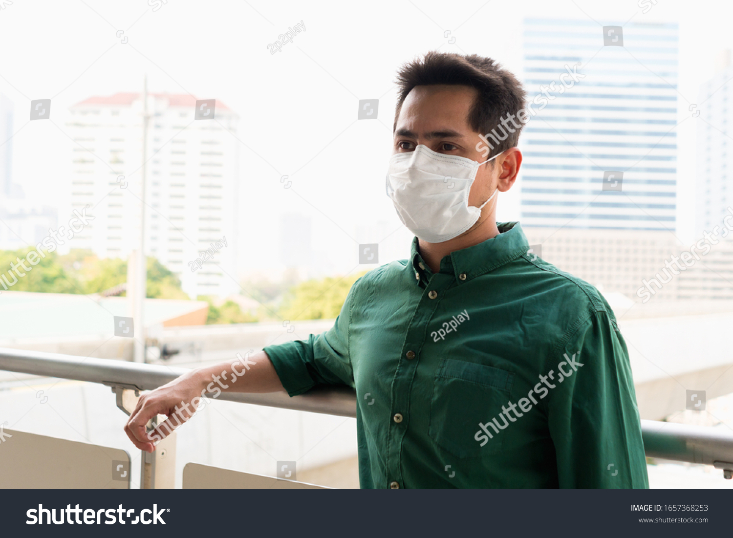 A man wearing mask protective for spreading of disease virus Covid-19 and  air smog pollution with PM 2.5 in Bangkok city, Thailand 2020. #1657368253
