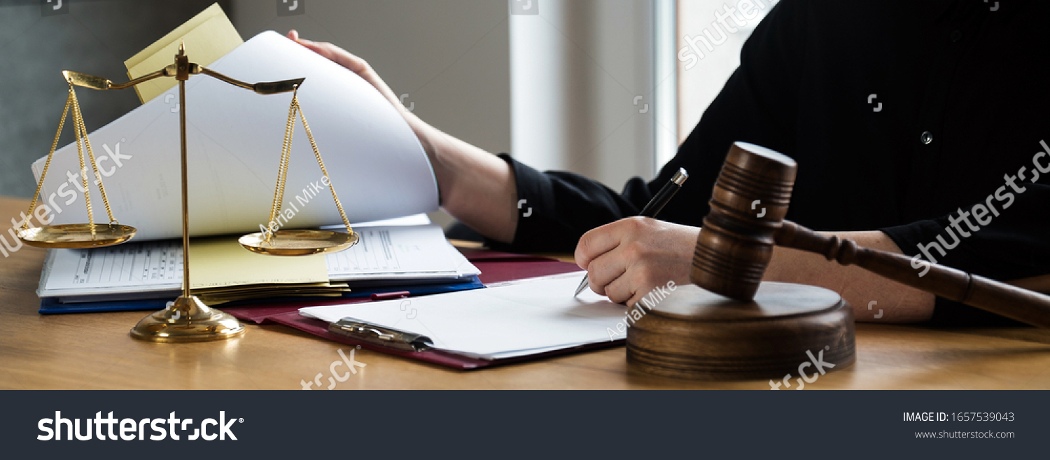  female lawyers working at the law firms. Judge gavel with scales of justice. Legal law, lawyer, advice and justice concept. #1657539043