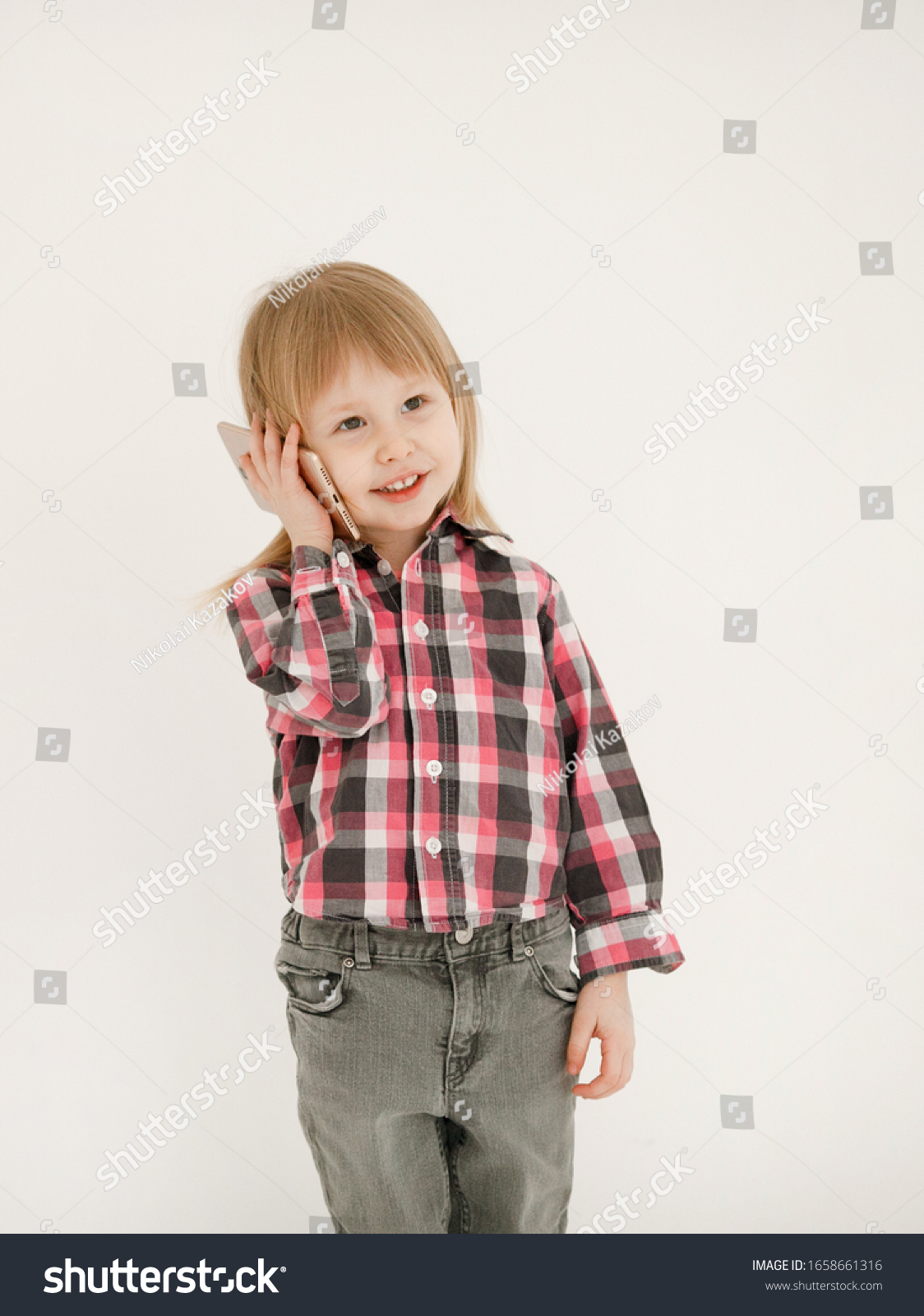 Emotional portrait of a cheerful and cheerful beautiful little girl looking with a smile in the mirror while using a smartphone with her grandmother, isolated on white background.Happy childhood #1658661316