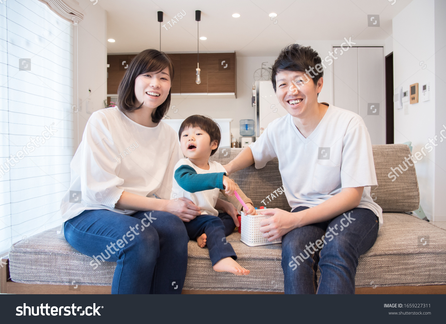 A family of three relaxing in the living room #1659227311
