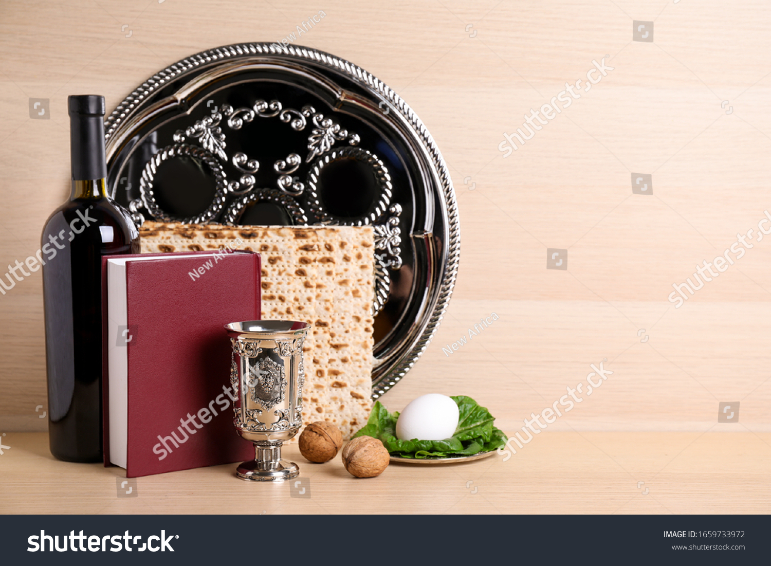 Symbolic Pesach (Passover Seder) items on wooden table, space for text #1659733972