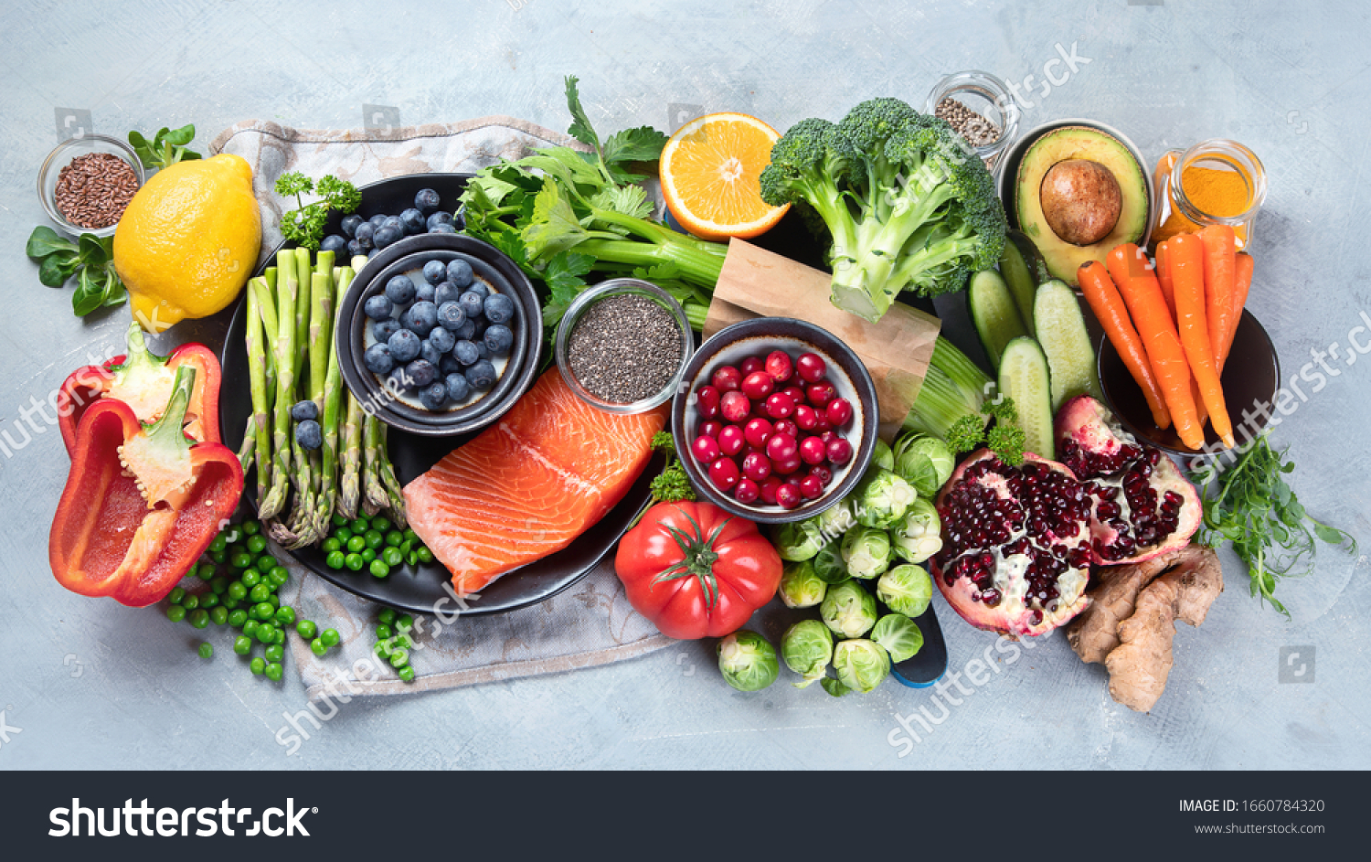 Healthy food selection on gray background. Detox and clean diet concept. Foods high in vitamins, minerals and antioxidants. Anti age foods. Top view #1660784320