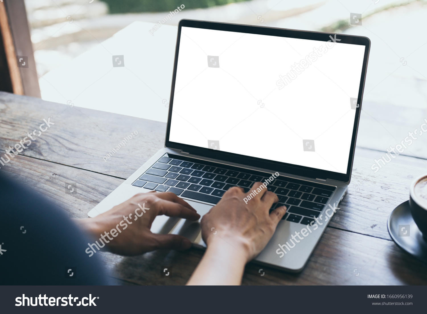computer mockup image blank screen with white background for advertising text,hand woman using laptop contact business search information on desk at coffee shop.marketing and creative design #1660956139