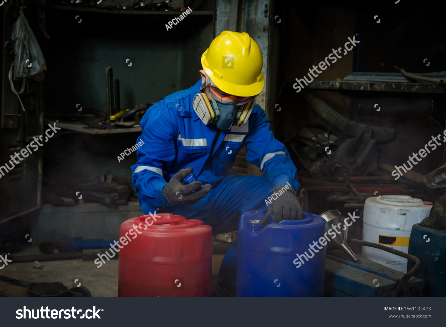 A Worker industry wearing safety uniform ,black gloves and gas mask under checking chemical tank in industry factory work #1661132473