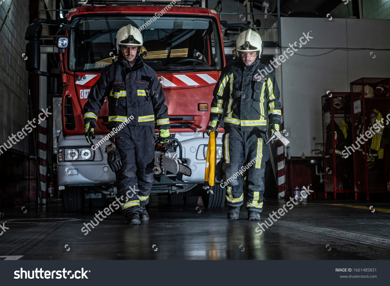 firemen leaving the station equipped and with the tools for the extinction of the fire #1661485831