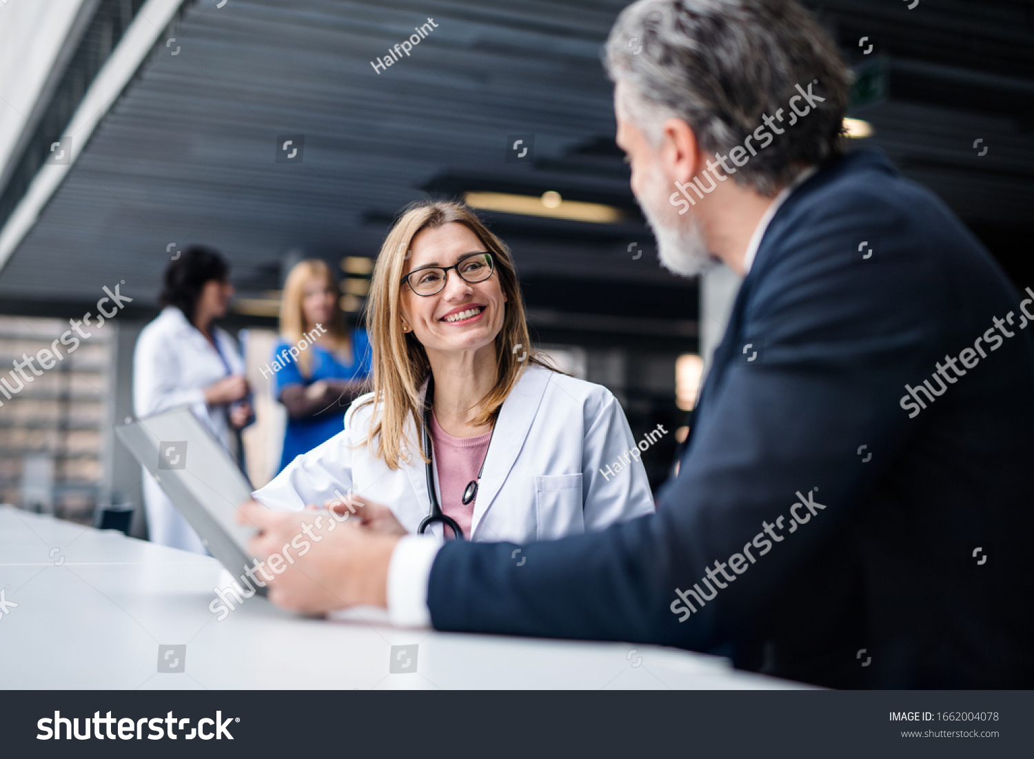 Doctor talking to a pharmaceutical sales representative. #1662004078