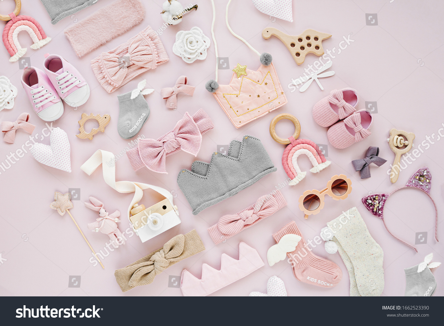 Set of  baby girl accessories on pink background. Various head band and hair bow, toy, little shoes, socks. Fashion kids stuff and accessories. Flat lay, top view #1662523390
